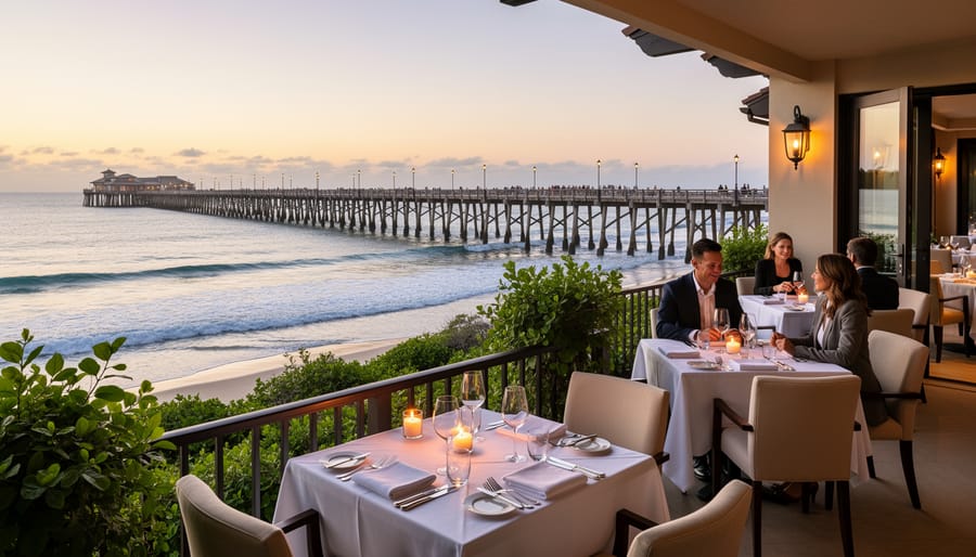 Couple near a waterfront wedding dining setup with a pier and ocean waves in the background at The Shore